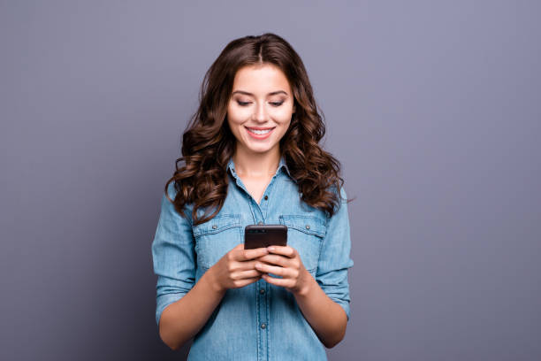 Display of current awards won overlapping a smiling female business owner working on computer